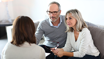 Couple meeting with an advisor for a property tax assessment review