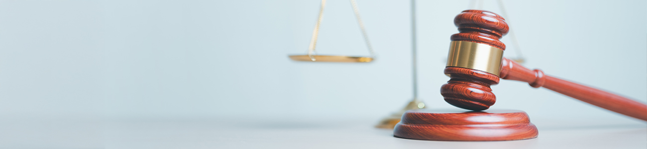 Judge's gavel with scales of justice in the background